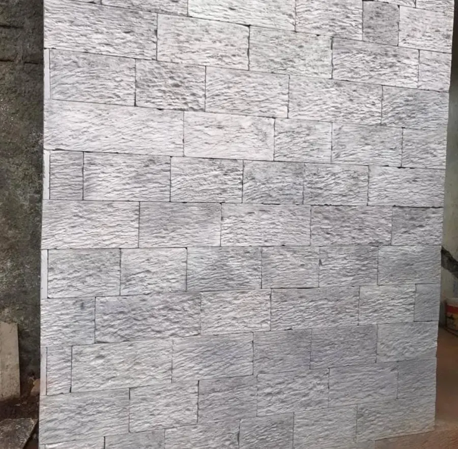 Grey smooth stone cladding on an outdoor wall