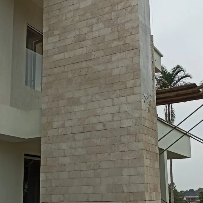 Coral stone cladding on a tall column