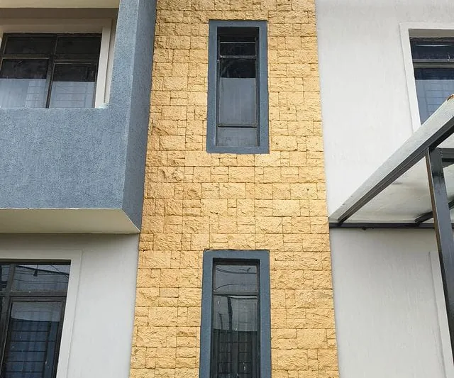 Yellow bush cladding strip between windows